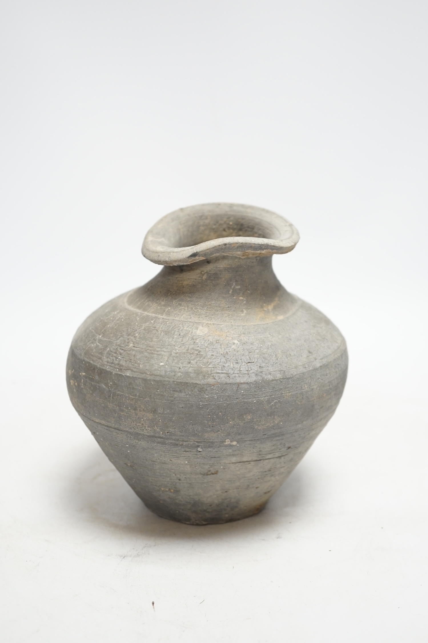 A Chinese grey pottery ribbed jar, probably Han dynasty, 19cm high